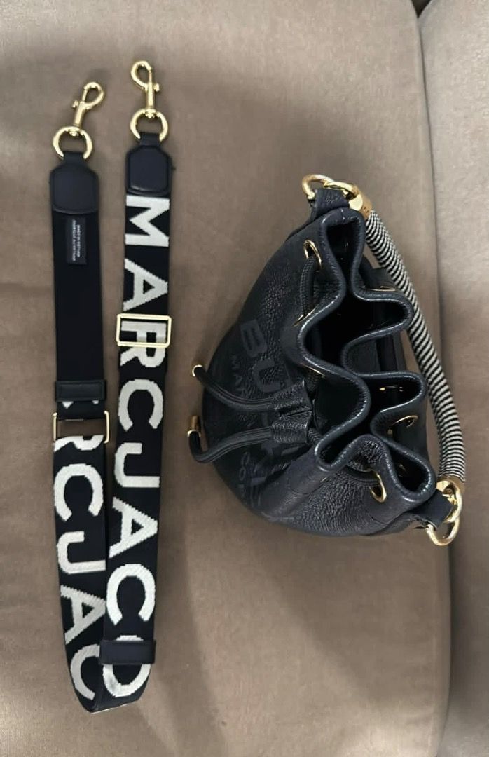 Marc Jacobs Black Leather Bucket Bag with Straps (Category: Luxury Bags & Wallets) located in Marikina City. Submitted by dinosgf (Listing ID 1442951391, Image 1). Description: - Authentic Marc Jacobs black leather bucket bag - Bought in Spain, 2025 - Original Price 34k - Features all-over embossed logo pattern - Comes with interchangeable strap: black & white logo strap - Secure drawstring closure - Includes a small top handle - Does not include