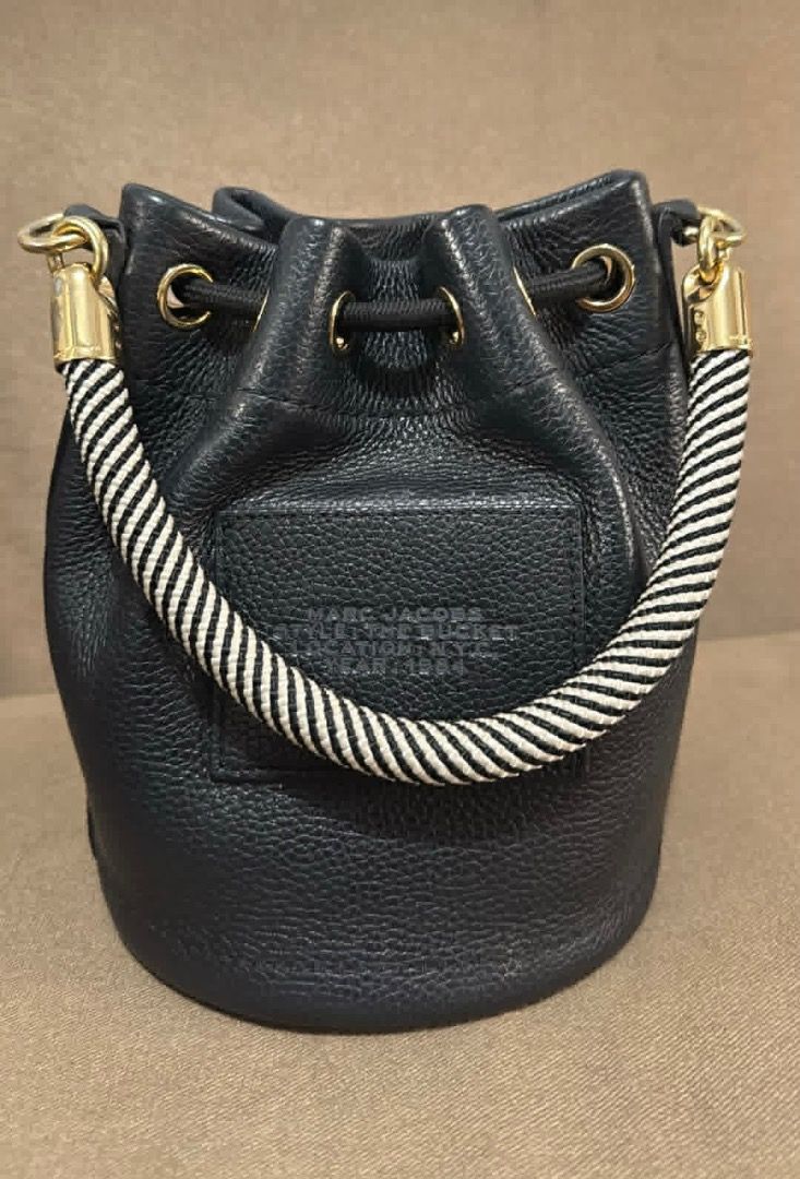 Marc Jacobs Black Leather Bucket Bag with Straps (Category: Luxury Bags & Wallets) located in Marikina City. Submitted by dinosgf (Listing ID 1442951391, Image 3). Description: - Authentic Marc Jacobs black leather bucket bag - Bought in Spain, 2025 - Original Price 34k - Features all-over embossed logo pattern - Comes with interchangeable strap: black & white logo strap - Secure drawstring closure - Includes a small top handle - Does not include