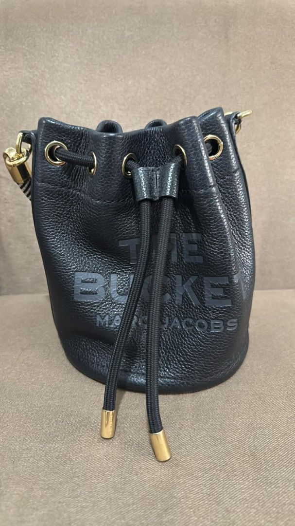 Marc Jacobs Black Leather Bucket Bag with Straps (Category: Luxury Bags & Wallets) located in Marikina City. Submitted by dinosgf (Listing ID 1442951391, Image 2). Description: - Authentic Marc Jacobs black leather bucket bag - Bought in Spain, 2025 - Original Price 34k - Features all-over embossed logo pattern - Comes with interchangeable strap: black & white logo strap - Secure drawstring closure - Includes a small top handle - Does not include