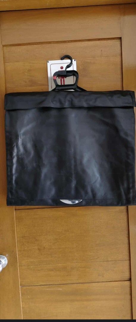Mini Cooper Black leather Garment Bag (Category: Luxury Bags & Wallets) located in Taguig. Submitted by thrifthub.ph (Listing ID 1443033498, Image 3). Description: - Black garment bag with Mini Cooper logo - Zipper closure for secure storage - Folds up easily for convenient storage - Ideal for travel or protecting garments - Approximate dimensions: 20" W x 24" H (when folded).