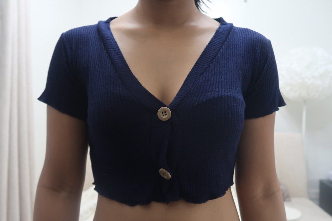Navy Blue Ribbed Cropped Cardigan with Buttons (Category: Coats, Jackets and Outerwear) located in Legazpi City. Submitted by theaslzr (Listing ID 1443013749, Image 2). Description: - Cute navy blue cropped cardigan - Ribbed knit fabric - Short sleeves - Two button front closures - Lettuce edge detail on the hem - Can be worn open or buttoned up - Highly versatile for various styling options.