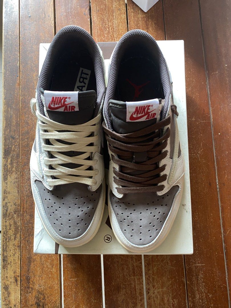 Nike Air Jordan 1 Low Travis Scott (Category: Sneakers) located in Pasay City. Submitted by studio_twentyph (Listing ID 1442929899, Image 1). Description: - Travis Scott Jordan 1 Lows - Includes original box - Comes with two sets of laces: cream and brown - Signature reverse swoosh design - Essential addition to any sneaker collection.