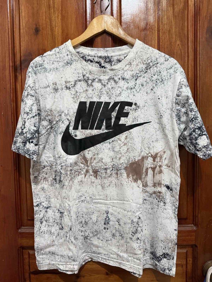 Nike T-Shirt Tie-Dye Graphic Tee (Category: Tshirts & Polo Shirts ) located in Taguig. Submitted by geestuff27 (Listing ID 1443087970, Image 1). Description: - Unique black, white, and brown tie-dye pattern - Classic Nike logo on the front - Versatile for casual outfits - Pairs well with jeans or shorts.