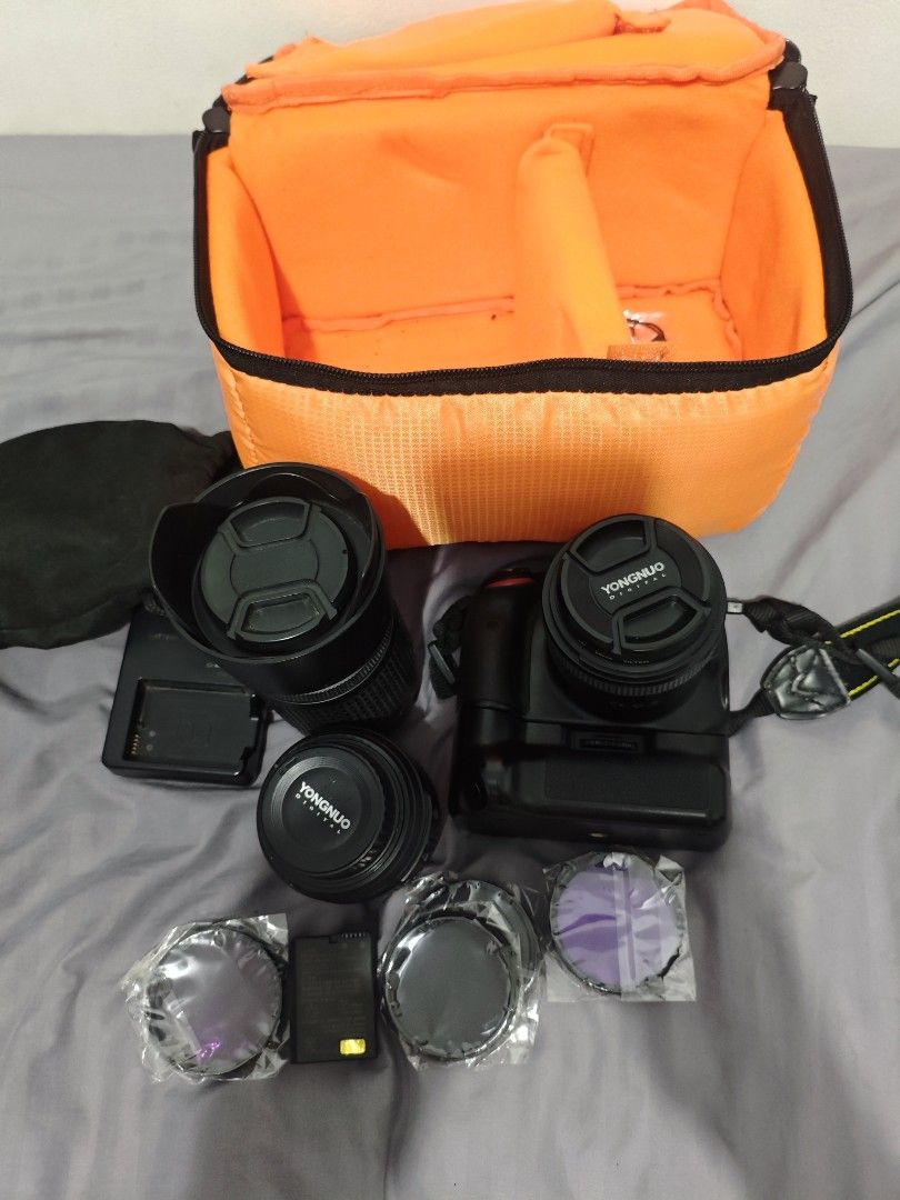 Nikon D5100 with 3 lenses (Category: Cameras) located in Quezon City. Submitted by brixl (Listing ID 1443053054, Image 3). Description: NIKON 5100 Nikon 18-55mm lens kit lens Nikon 55-200 mm kit lens Youngnuo 35mm bought last 2022 Battery Grip 2 battery 1 charger Lens filter Camera Bag NO memory card. Issue: One battery need replacement mild swelling. 200 mm lens mild dents due to it was stuck and not using. For the Yongnuo lens, I barely used it
