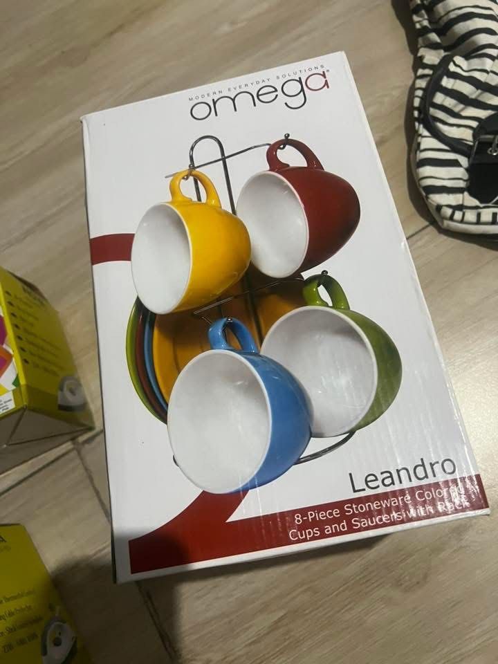 Omega Stoneware Cups and Saucers Set with Rack (Category: Coffee & Tea Tableware) located in Pasig City. Submitted by amxene (Listing ID 1442991969, Image 1). Description: - Omega Leandro 8-piece stoneware cups and saucers set - Includes a convenient rack for storage - Features vibrant, colorful cups in yellow, red, blue, and green - Ideal for enjoying your coffee or tea - Modern design for everyday use.