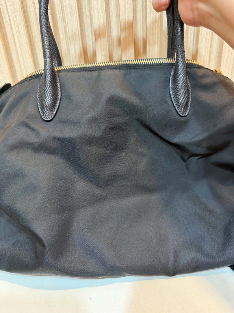 Prada Nylon Tote Bag with Bear Charm (Category: Luxury Bags & Wallets) located in Quezon City. Submitted by kymis (Listing ID 1443119584, Image 3). Description: - Authentic Black Prada Nylon Tote Bag - Features a cute teddy bear charm - Genuine leather trim and handles - Elegant gold-tone hardware - Comes with a detachable shoulder strap - Ideal for everyday use -Coating along the handle has cracked, peeled a little.