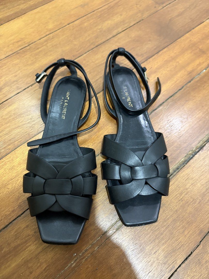Saint Laurent Black Leather Tribute Flat Sandals (Category: Flats & Sandals) located in Taguig. Submitted by onein.oneout_declutter (Listing ID 1443120838, Image 1). Description: - Authentic Black Leather Saint Laurent Tribute Flat Sandals - Features iconic woven strap detail across the front - Adjustable ankle strap with buckle closure for a secure fit - Classic YSL design, versatile for dressing up or down.