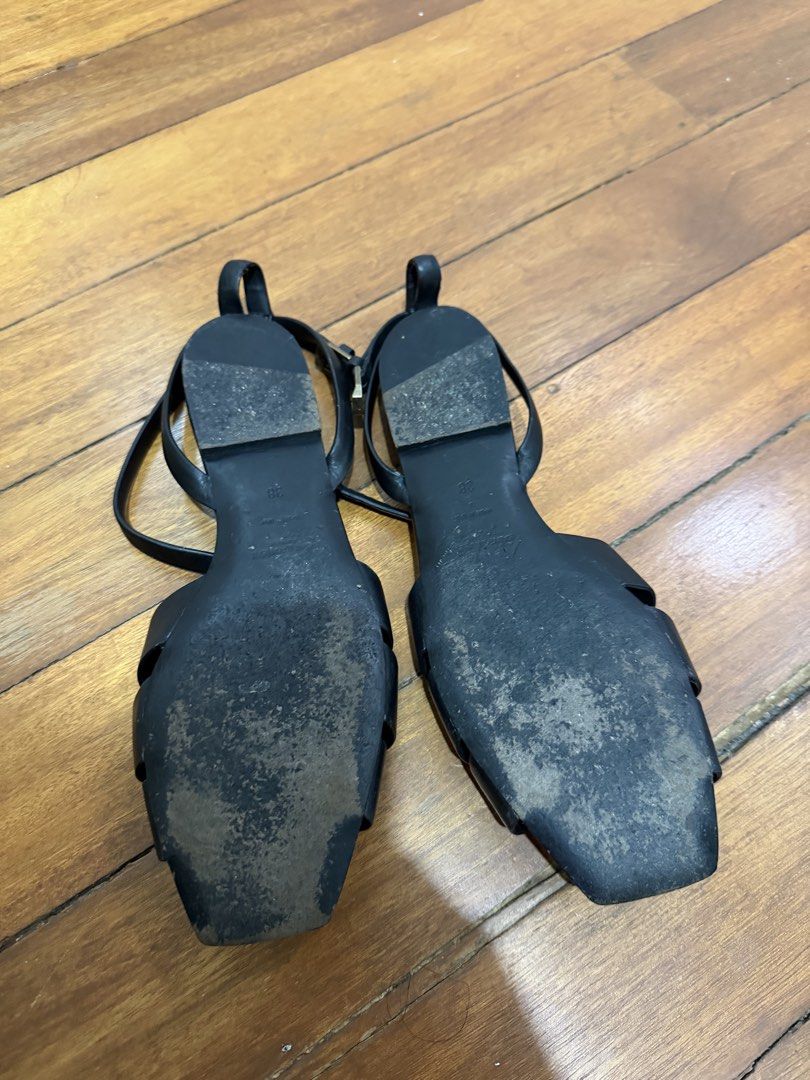 Saint Laurent Black Leather Tribute Flat Sandals (Category: Flats & Sandals) located in Taguig. Submitted by onein.oneout_declutter (Listing ID 1443120838, Image 3). Description: - Authentic Black Leather Saint Laurent Tribute Flat Sandals - Features iconic woven strap detail across the front - Adjustable ankle strap with buckle closure for a secure fit - Classic YSL design, versatile for dressing up or down.