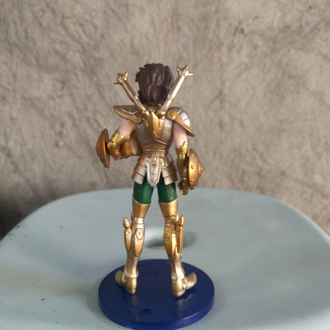 Saint Seiya Libra Dohko Action Figure (Category: Figurines & Statues) located in Plaridel. Submitted by klayskolektibols (Listing ID 1443008699, Image 3). Description: - Saint Seiya Libra Dohko action figure - Features iconic gold armor and green pants - Comes with a display base - Base is blue with 'LIBRA' inscription - Ideal for Saint Seiya collectors.