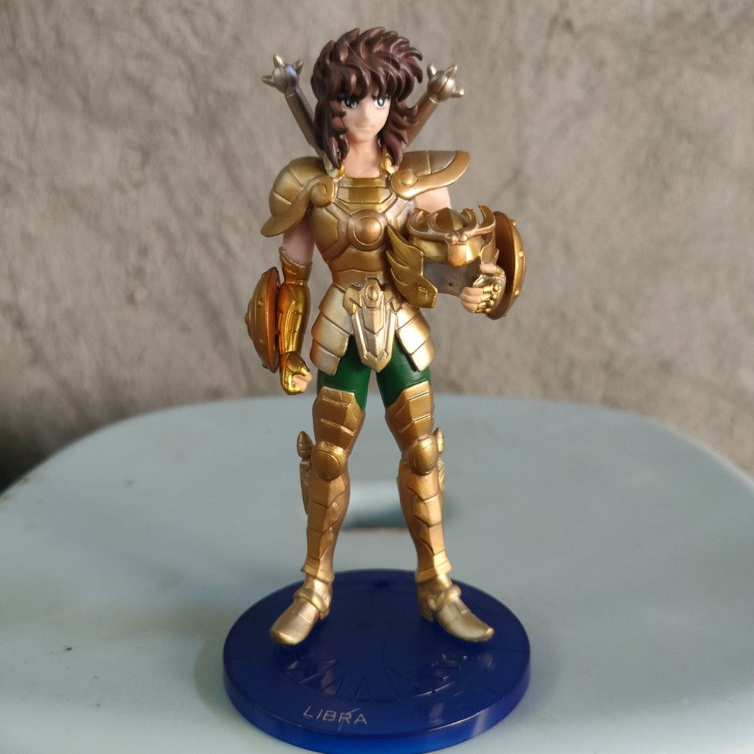 Saint Seiya Libra Dohko Action Figure (Category: Figurines & Statues) located in Plaridel. Submitted by klayskolektibols (Listing ID 1443008699, Image 1). Description: - Saint Seiya Libra Dohko action figure - Features iconic gold armor and green pants - Comes with a display base - Base is blue with 'LIBRA' inscription - Ideal for Saint Seiya collectors.