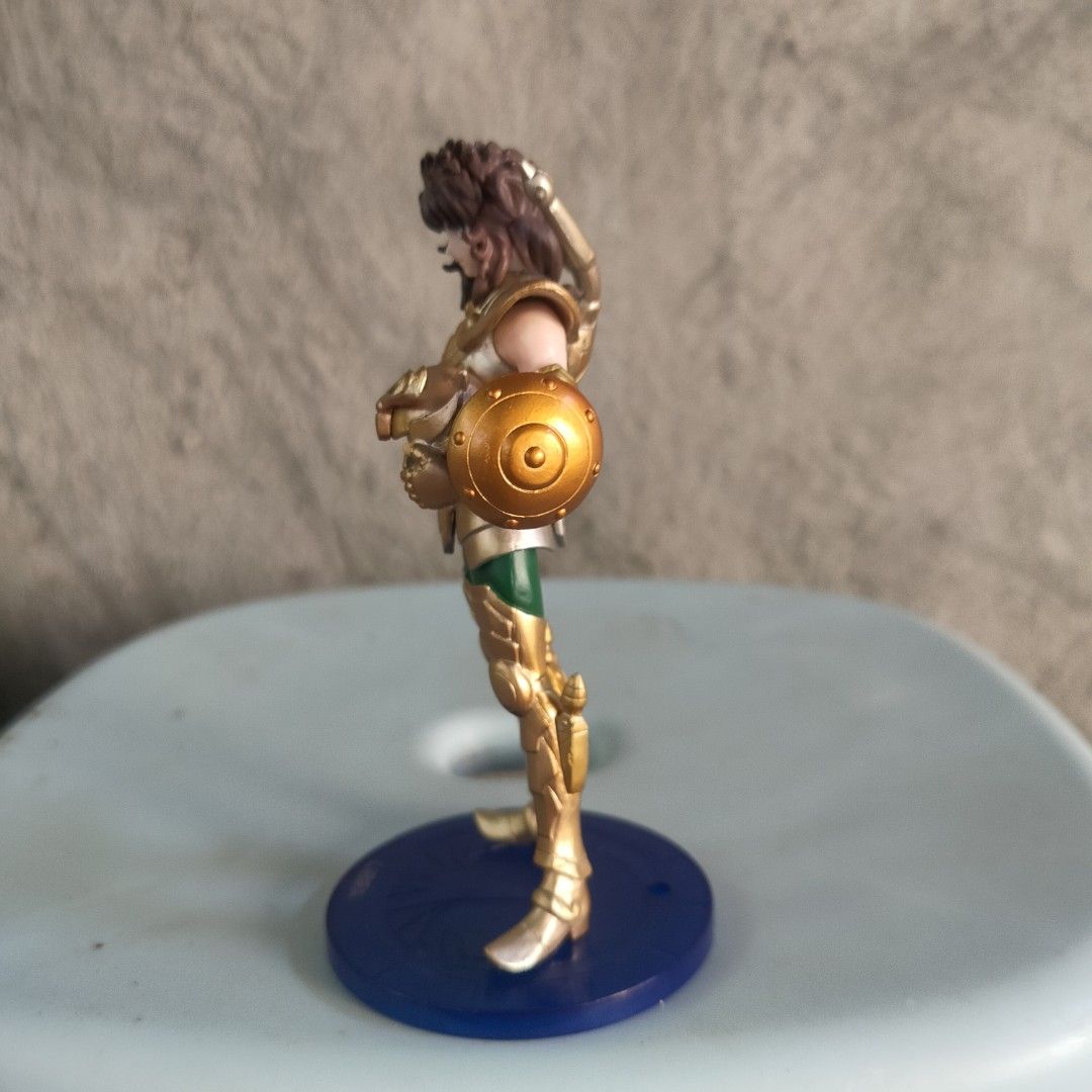 Saint Seiya Libra Dohko Action Figure (Category: Figurines & Statues) located in Plaridel. Submitted by klayskolektibols (Listing ID 1443008699, Image 2). Description: - Saint Seiya Libra Dohko action figure - Features iconic gold armor and green pants - Comes with a display base - Base is blue with 'LIBRA' inscription - Ideal for Saint Seiya collectors.