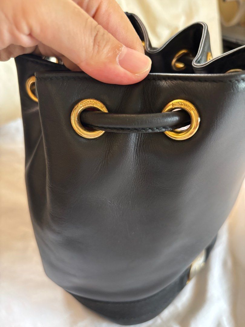 Salvatore Ferragamo bucket bag (Category: Luxury Bags & Wallets) located in Tarlac. Submitted by vectorreyes (Listing ID 1442998838, Image 2). Description: -Authentic Salvatore Ferragamo Vara Bow bucket bag -in smooth black leather, likely calfskin, featuring gold-tone hardware, drawstring closure, Ferragamo-engraved eyelets, adjustable shoulder straps. -Made in Italy. -Serial/code: AQ215676. -vintage -collectors item -rare bucket bag of ferra.