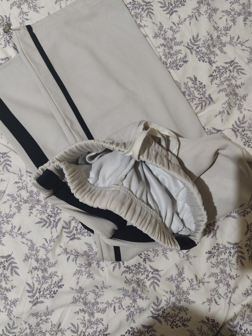 off-white track pants (Category: Joggers) located in Bulacan. Submitted by angel.decluttersx (Listing ID 1443067873, Image 3). Description: M-L size thick fabric with elastic drawstring waistband material: cotton flaw: minimal stain due to zonrox laundry.