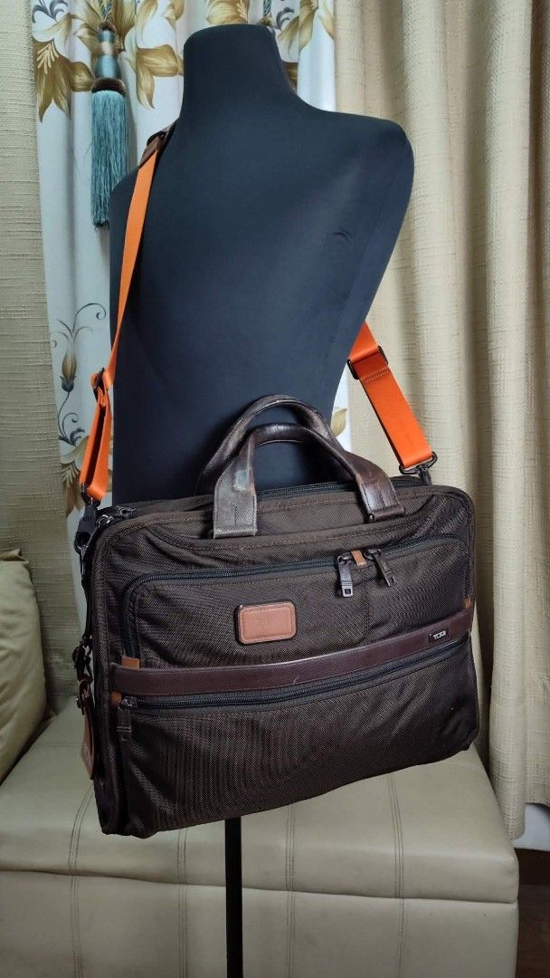 Tumi Brown Ballistic Nylon Leather Trim Briefcase Bag (Category: Briefcases) located in Quezon City. Submitted by edwinvuru (Listing ID 1442976474, Image 2). Description: - Brand: Tumi - Color: Brown - Material: Ballistic nylon with leather trim - Features: Multiple interior compartments for organization - Straps: Top handles and detachable shoulder strap - Ideal for: Work and travel - Design: Durable and functional.