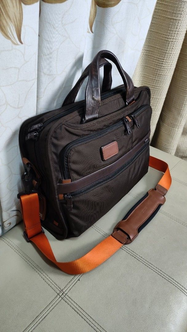 Tumi Brown Ballistic Nylon Leather Trim Briefcase Bag (Category: Briefcases) located in Quezon City. Submitted by edwinvuru (Listing ID 1442976474, Image 1). Description: - Brand: Tumi - Color: Brown - Material: Ballistic nylon with leather trim - Features: Multiple interior compartments for organization - Straps: Top handles and detachable shoulder strap - Ideal for: Work and travel - Design: Durable and functional.