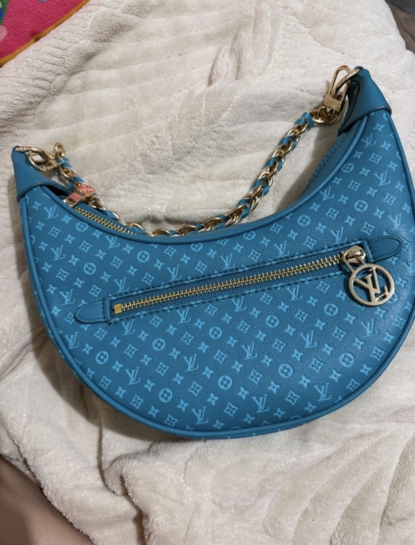 Turquoise teal Monogram Crescent Shoulder Bag (Category: Luxury Bags & Wallets) located in Pasig City. Submitted by khaid (Listing ID 1443032699, Image 1). Description: - Chic turquoise shoulder bag with repeating monogram pattern. - Elegant gold chain strap and zipper details. - Convenient front zip pocket for quick access. - Spacious main compartment to hold your essentials. - Interior matches the stylish turquoise exterior..