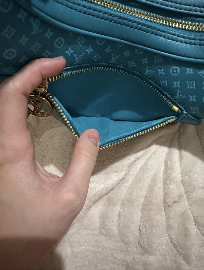 Turquoise teal Monogram Crescent Shoulder Bag (Category: Luxury Bags & Wallets) located in Pasig City. Submitted by khaid (Listing ID 1443032699, Image 2). Description: - Chic turquoise shoulder bag with repeating monogram pattern. - Elegant gold chain strap and zipper details. - Convenient front zip pocket for quick access. - Spacious main compartment to hold your essentials. - Interior matches the stylish turquoise exterior..