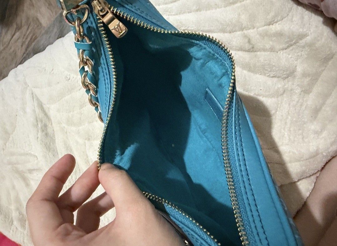 Turquoise teal Monogram Crescent Shoulder Bag (Category: Luxury Bags & Wallets) located in Pasig City. Submitted by khaid (Listing ID 1443032699, Image 3). Description: - Chic turquoise shoulder bag with repeating monogram pattern. - Elegant gold chain strap and zipper details. - Convenient front zip pocket for quick access. - Spacious main compartment to hold your essentials. - Interior matches the stylish turquoise exterior..