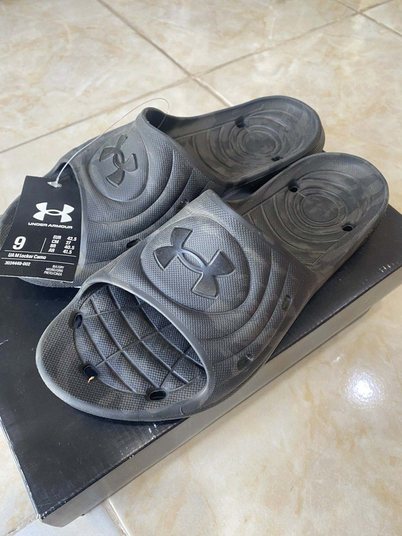 Under Armour UA M Locker Camo Slides (Category: Slippers & Slides) located in Pinamalayan. Submitted by chay0921 (Listing ID 1443046174, Image 1). Description: - Brand: Under Armour - Model: UA M Locker Camo Slides - Color: Black - Size: US Men's 9 - Condition: Brand new with original tag - Ideal for: Casual wear, post-sports recovery.
