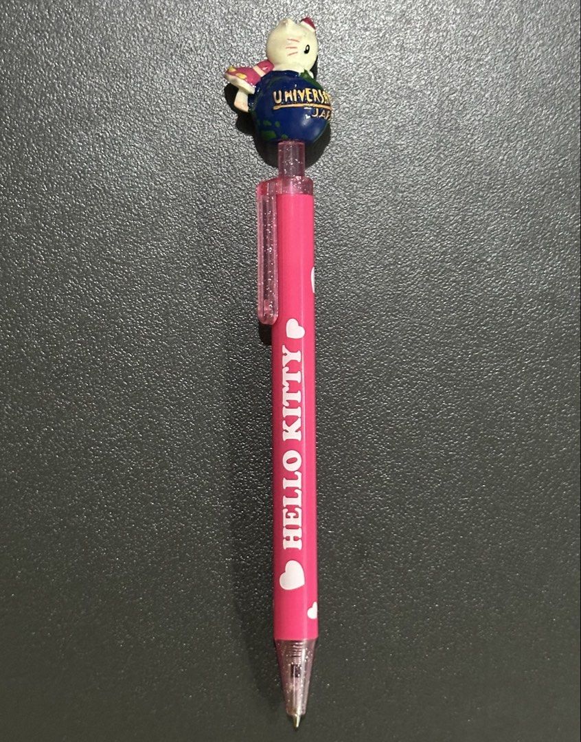 Universal Studios Hello Kitty Pen with Globe Topper (Category: Stationery & School Supplies) located in Manila. Submitted by sharksfin06 (Listing ID 1443026817, Image 1). Description: NEEDS REFILL !!! LOC: San Miguel, Manila MOP: Gcash MOD: Lalamove - Adorable pink Kitty pen. - Features ' Kitty' text with heart accents. - Unique globe topper with a Kitty figure. - Writes smoothly for a pleasant writing experience. - Ideal gift for Kitty enthusias