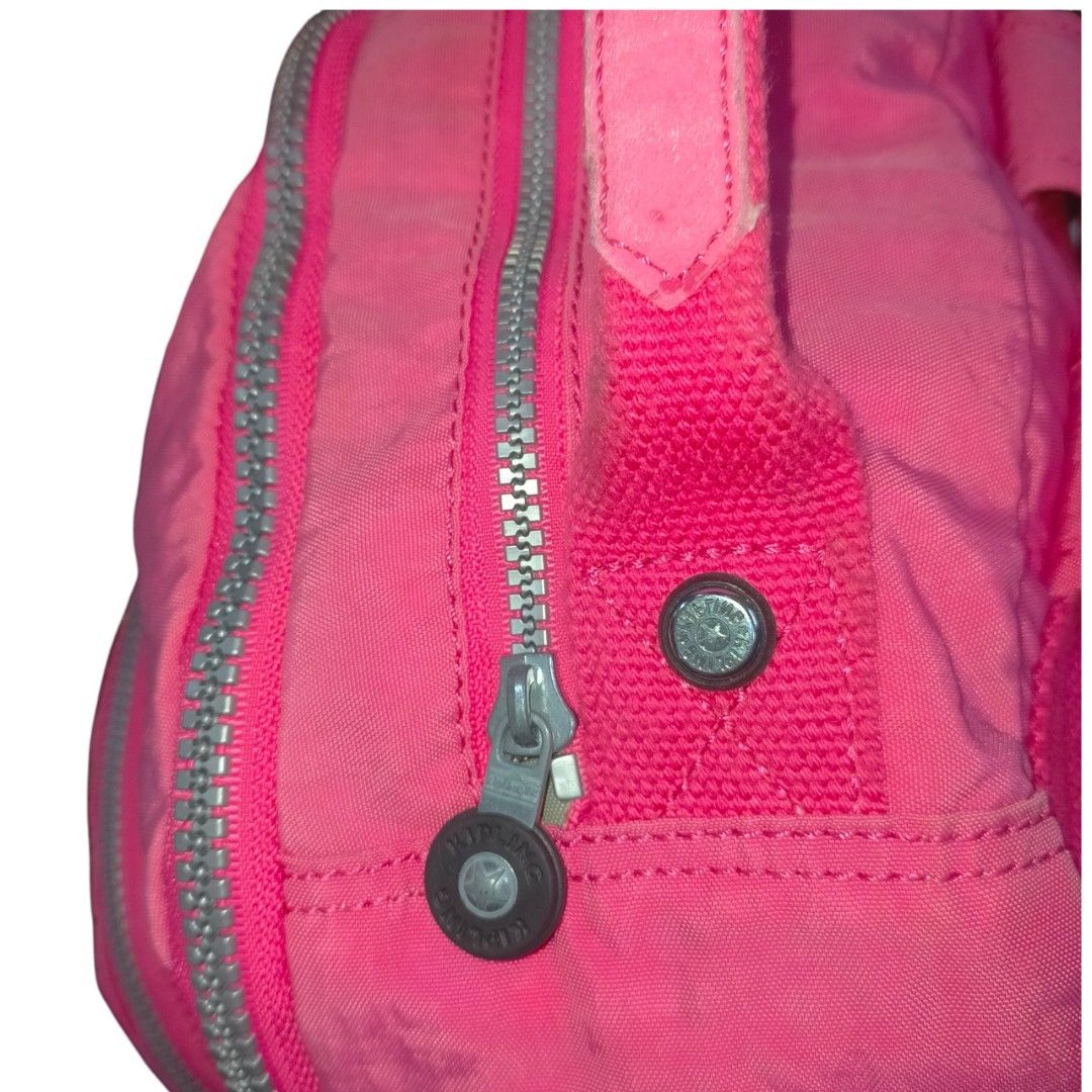 Vibrant pink Kipling Seoul backpack Large (Category: Backpacks) located in Taguig. Submitted by agenttin (Listing ID 1442964994, Image 2). Description: This vibrant pink Kipling Seoul backpack features a durable nylon design with organized compartments and a signature branded circular logo. Features: Typically includes a laptop compartment and water bottle pockets source: Japan Surplus no monkey chain.