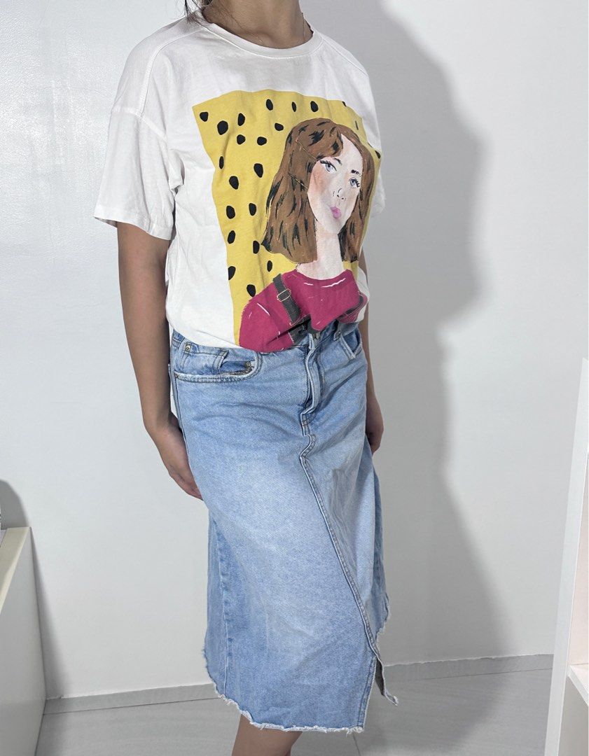 White Graphic Tee with Denim Midi Skirt (Category: Sets or Coordinates) located in Agdangan. Submitted by mvania (Listing ID 1443013496, Image 3). Description: - White t-shirt with a cool graphic print of a girl - Relaxed fit for comfort - Light wash denim midi skirt - Skirt features a raw hem and front slit - Versatile outfit: wear together or separately - Ideal for casual everyday wear.