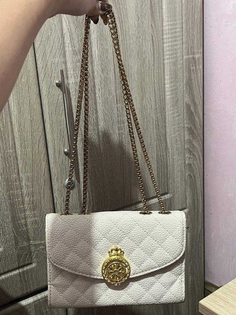 Shoulder Bag (Valencia) (Category: Luxury Bags & Wallets) located in Angeles City. Submitted by ruelle2610 (Listing ID 1443086727, Image 1). Description: - Elegant white quilted handbag - Luxurious gold chain strap - Textured exterior for added detail - Decorative gold crown clasp adorned with sparkling rhinestones - Interior zippered compartment for secure storage - Ideal for dressing up your outfits and adding a touch of glam.