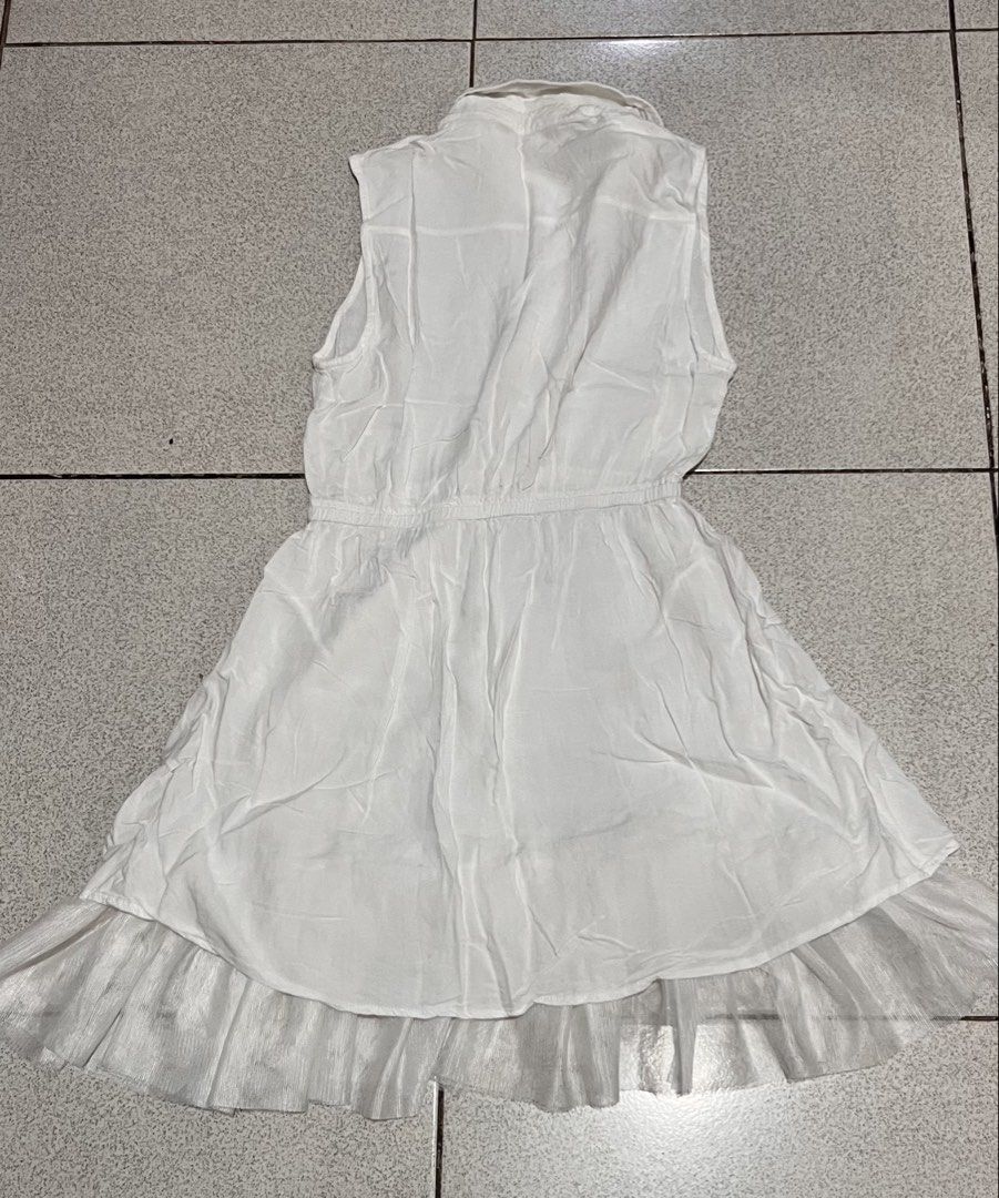 White Sleeveless Collared Dress with Ruffle Hem (Category: Dresses) located in Lipa City. Submitted by emscorner (Listing ID 1442959110, Image 1). Description: - White sleeveless dress - Collared neckline with button-up front - Elasticated waist for a comfortable fit - Flirty ruffle hem detail - Lightweight material, perfect for warm weather - Ideal for casual outings or dressing up for occasions.