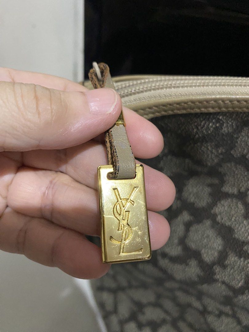 Yves Saint Laurent YSL Monogram Tote Bag (Category: Luxury Bags & Wallets) located in Manila. Submitted by resi.diaz (Listing ID 1443001002, Image 3). Description: - Bought from Surplus. Not professionally authenticated. - Sold as is. - Iconic YSL Monogram Print All Over - Beige Leather Trim and Handles - Gold Tone Hardware with YSL Logo Charm - Secure Zipper Closure - Ideal for Travel or Everyday Use - Shows some signs of wear on hardware and le