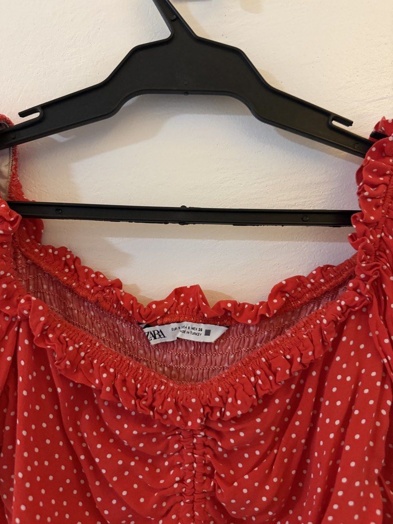 Zara Red Polka Dot Ruched Crop Top (Category: Blouses) located in Bacoor. Submitted by conclaseph (Listing ID 1442946799, Image 3). Description: - Adorable red crop top with white polka dots. - Features a flattering smocked bust. - Adjustable drawstring tie at the front hem. - Stylish puff sleeves with elasticated cuffs. - Chic off-the-shoulder neckline. - Versatile for casual days or nights with friends..