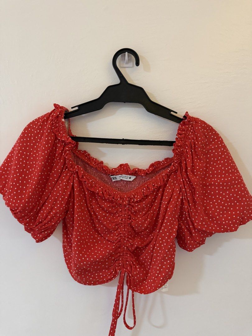 Zara Red Polka Dot Ruched Crop Top (Category: Blouses) located in Bacoor. Submitted by conclaseph (Listing ID 1442946799, Image 2). Description: - Adorable red crop top with white polka dots. - Features a flattering smocked bust. - Adjustable drawstring tie at the front hem. - Stylish puff sleeves with elasticated cuffs. - Chic off-the-shoulder neckline. - Versatile for casual days or nights with friends..