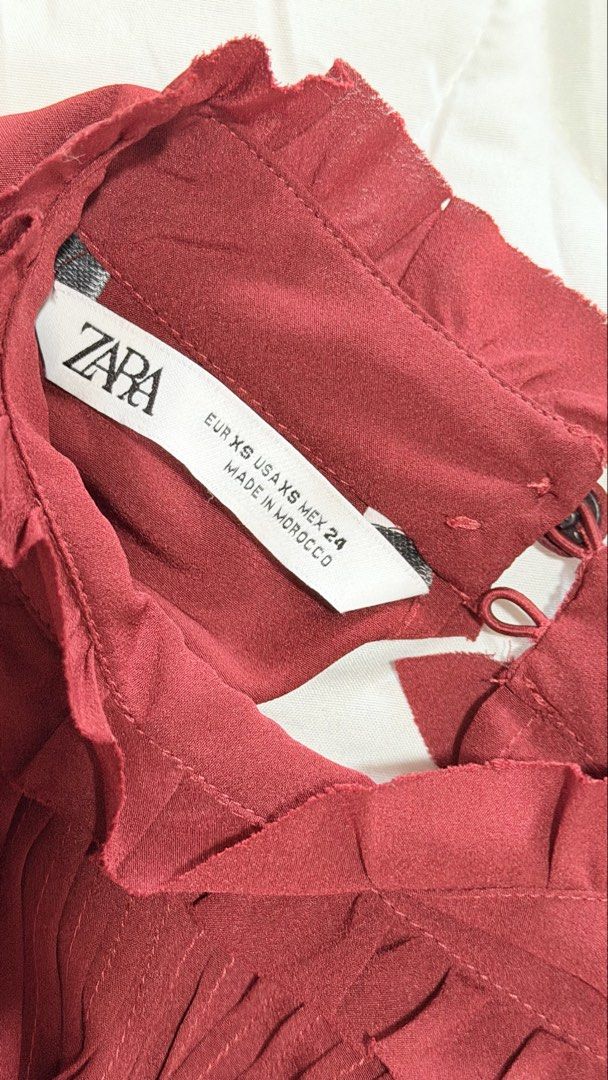 Zara Red Ruffled High Neck Long Sleeve Blouse (Category: Blouses) located in Manila. Submitted by hellokittyjhoe (Listing ID 1442970752, Image 2). Description: - Zara red blouse - High ruffled neckline - Long sleeves with ruffled cuffs - Pleated detail on the front - Button closure at the back of the neck - Made in Morocco.