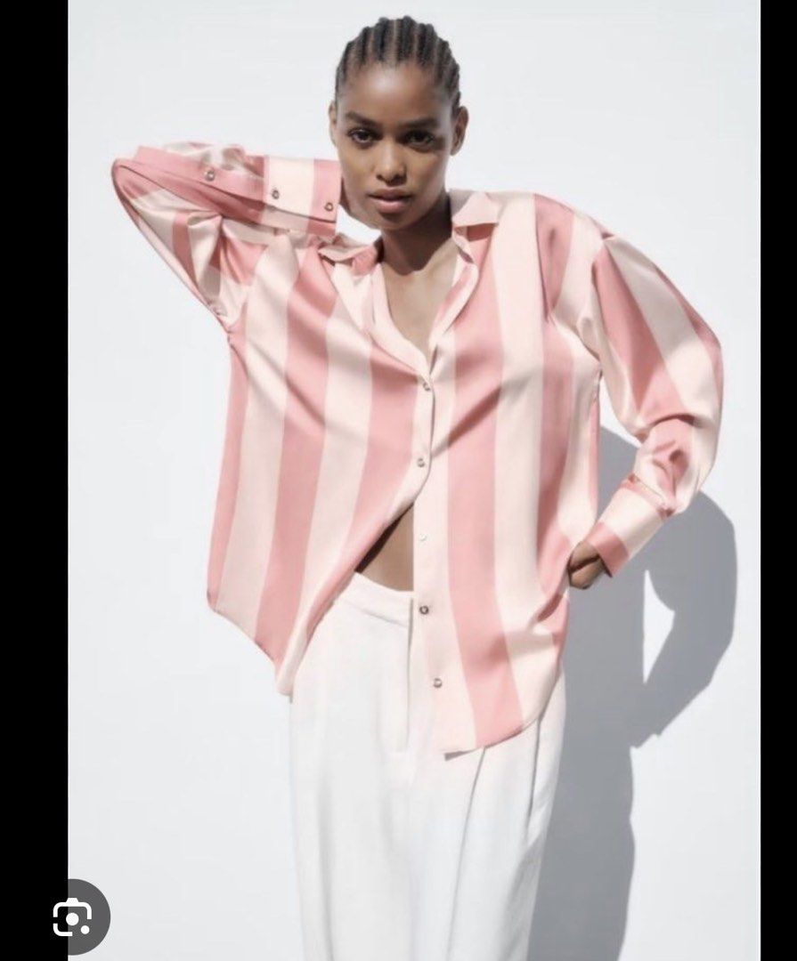 Zara Striped Satin Oversized Shirt (Category: Shirts) located in San Juan City. Submitted by nadssg (Listing ID 1442941484, Image 2). Description: - Zara oversized button-up shirt - Pink and white vertical stripes - Silky satin material - Can be worn open or buttoned up - Versatile styling for casual or dressed-up occasions.