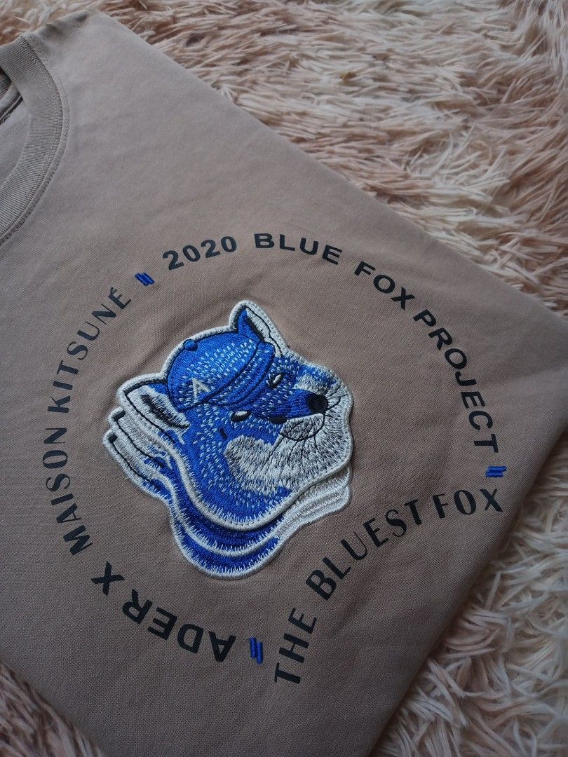 ADER error x Maison Kitsuné Blue Fox Project T-shirt (Category: Tshirts & Polo Shirts ) located in Boston. Submitted by johnpaulvi30029 (Listing ID 1443224831, Image 3). Description: - ADER error x Maison Kitsuné collaboration tee - Features the Blue Fox Project graphic - Neutral beige color - Perfect for casual outfits.