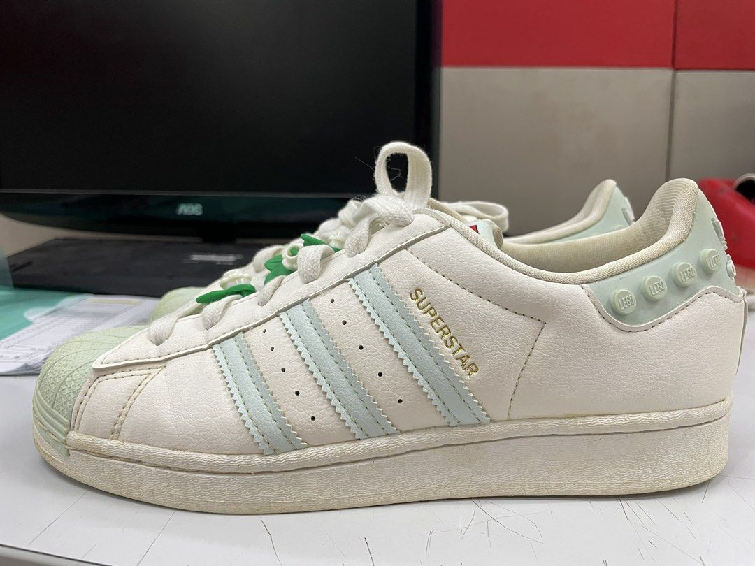 Adidas Superstar x LEGO Shoes (Category: Sneakers) located in Manila. Submitted by _maryan.marcial (Listing ID 1443141997, Image 3). Description: - Clear White Ice Mint Adidas Superstar sneakers - US Women's Size 7 - Light blue accents - Fun LEGO brick detail on the heel - Cute flower lace charms - LEGO logo on the tongue - Made in Indonesia.