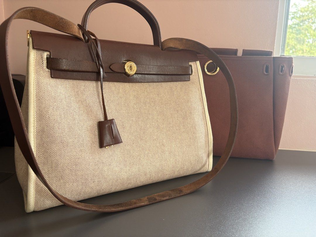 Authentic Hermes Herbag Bag‼️ (Category: Luxury Bags & Wallets) located in Makati City. Submitted by nearly-new (Listing ID 1443212101, Image 2). Description: VERY GOOD DEAL‼️ Hermès Herbag 31 in natural canvas with brown leather trim and gold hardware. Includes the removable shoulder strap and an additional interchangeable Herbag canvas body in a different color. Would be delighted to arrange a viewing for serious buyers to appreciate the detail