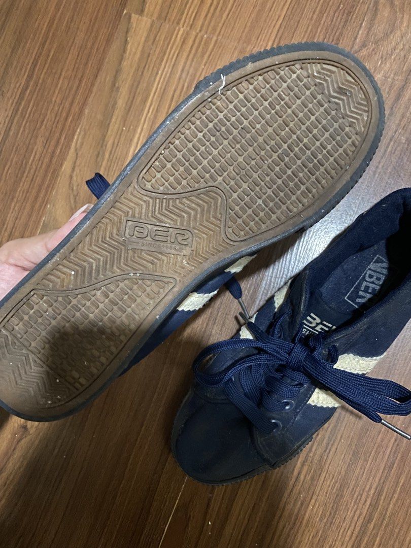 BER Navy Blue Sneakers with White Stripes (Category: Sneakers) located in San Juan City. Submitted by helpabaddietodecclutter (Listing ID 1443132513, Image 3). Description: - BER Navy Blue Sneakers - Features a classic white stripe design - Lace-up closure for a secure fit - Size 37 (UK 4 / US 6) - 'BER since 1994' branding visible on the sole - Shows minor signs of dust and wear, adding character - Perfect for everyday casual wear.
