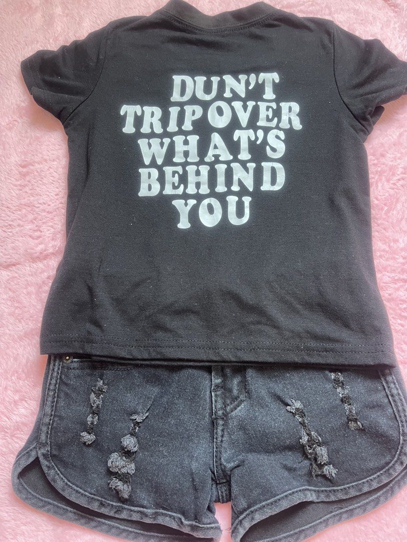 Black Graphic Tee & Distressed Denim Shorts Set (Category: Sets or Coordinates) located in Paombong. Submitted by declutteredbychee_ (Listing ID 1443193706, Image 2). Description: - Black graphic t-shirt with 'DON'T TRIP OVER WHAT'S BEHIND YOU' print on the back. - Black distressed denim shorts with raw hem and ripped details. - Stylish and comfortable casual outfit. - Ready to wear..