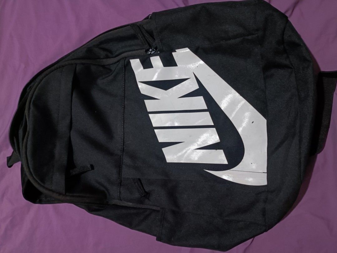 Black Nike Backpack with Large White Swoosh Logo (Category: Backpacks) located in Manila. Submitted by parcanon (Listing ID 1443151718, Image 1). Description: - Classic black Nike backpack - Iconic large white Swoosh logo - Spacious main compartment for essentials - Convenient side pockets for water bottles or quick access items - Adjustable shoulder straps for comfortable carrying - Ideal for school, gym, or everyday use -issue print .