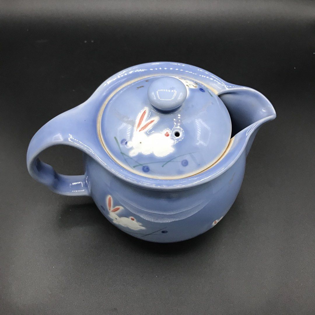 Blue Ceramic Teapot with Bunny Design (Category: Coffee & Tea Tableware) located in Baao. Submitted by all.things.japan (Listing ID 1443134513, Image 2). Description: - Adorable blue ceramic teapot - Features charming white bunnies and blue dots all over - Comes with a comfortable handle - Includes a lid with a small knob for easy pouring - Perfect for serving your favorite teas - Makes a wonderful gift for tea lovers or a lovely decorative accen