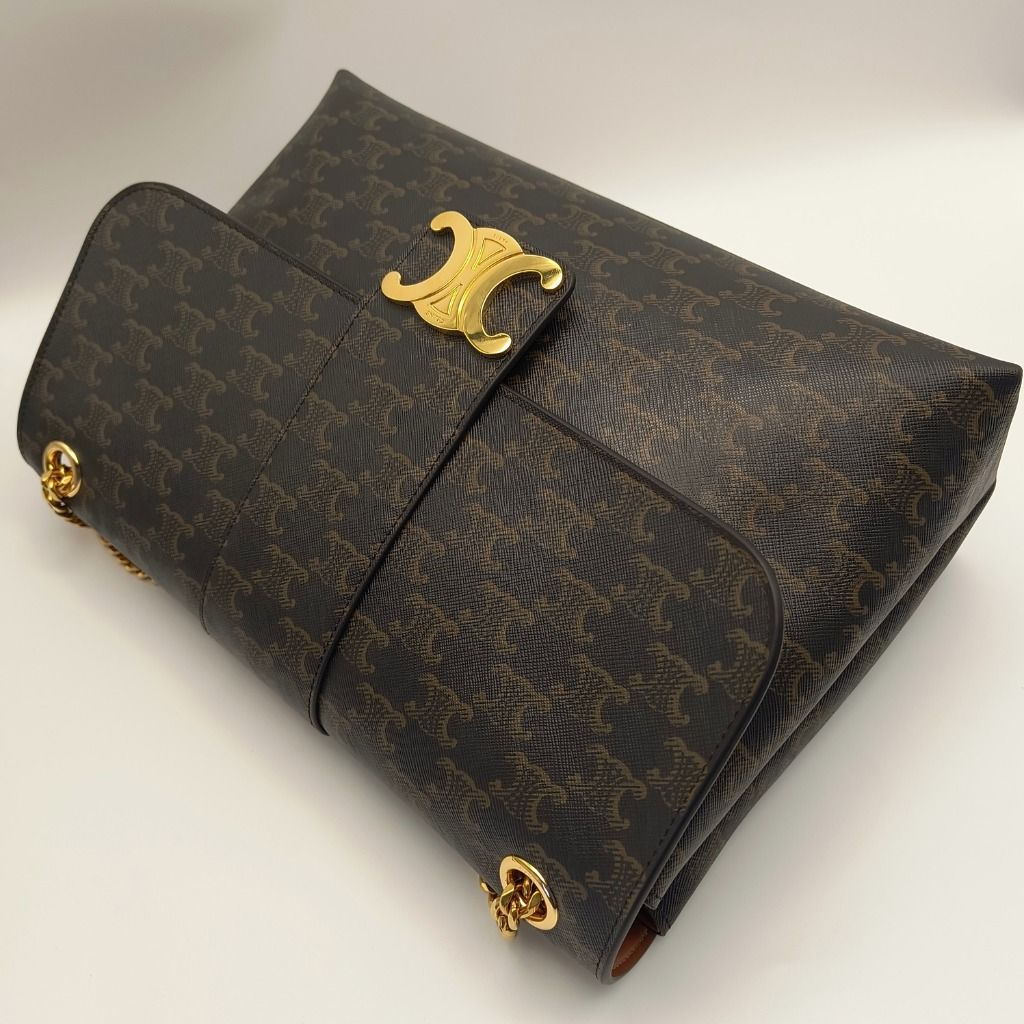Celine Triomphe Monogram Chain Shoulder Bag (Category: Luxury Bags & Wallets) located in Cebu City. Submitted by theluxxaffair (Listing ID 1443243838, Image 2). Description: Celine Triomphe shoulder bag in signature Triomphe monogram canvas with gold-tone hardware. Features the iconic Triomphe clasp, sliding chain strap, and a structured flap silhouette. Lined in tan leather with multiple interior compartments and a zip pocket for organization. I
