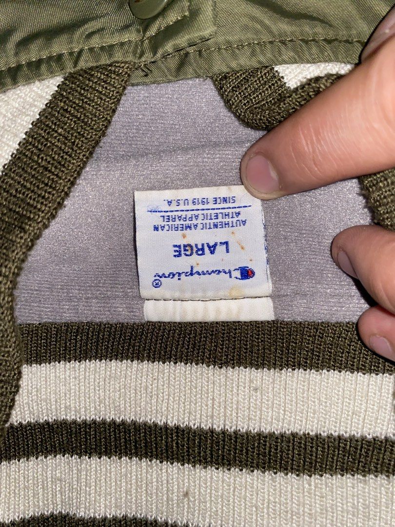Champion Olive Green Varsity Bomber Jacket Size L (Category: Coats, Jackets and Outerwear) located in Manila. Submitted by jorjaalice (Listing ID 1443223989, Image 2). Description: - Olive green Champion varsity bomber jacket - White and green striped collar, cuffs, and hem - Button-up front closure - Classic athletic style - Ideal for layering - Size: Large.