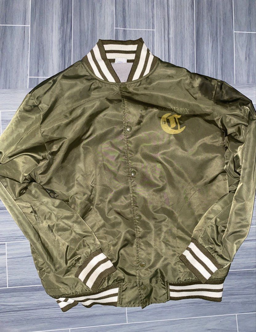 Champion Olive Green Varsity Bomber Jacket Size L (Category: Coats, Jackets and Outerwear) located in Manila. Submitted by jorjaalice (Listing ID 1443223989, Image 1). Description: - Olive green Champion varsity bomber jacket - White and green striped collar, cuffs, and hem - Button-up front closure - Classic athletic style - Ideal for layering - Size: Large.