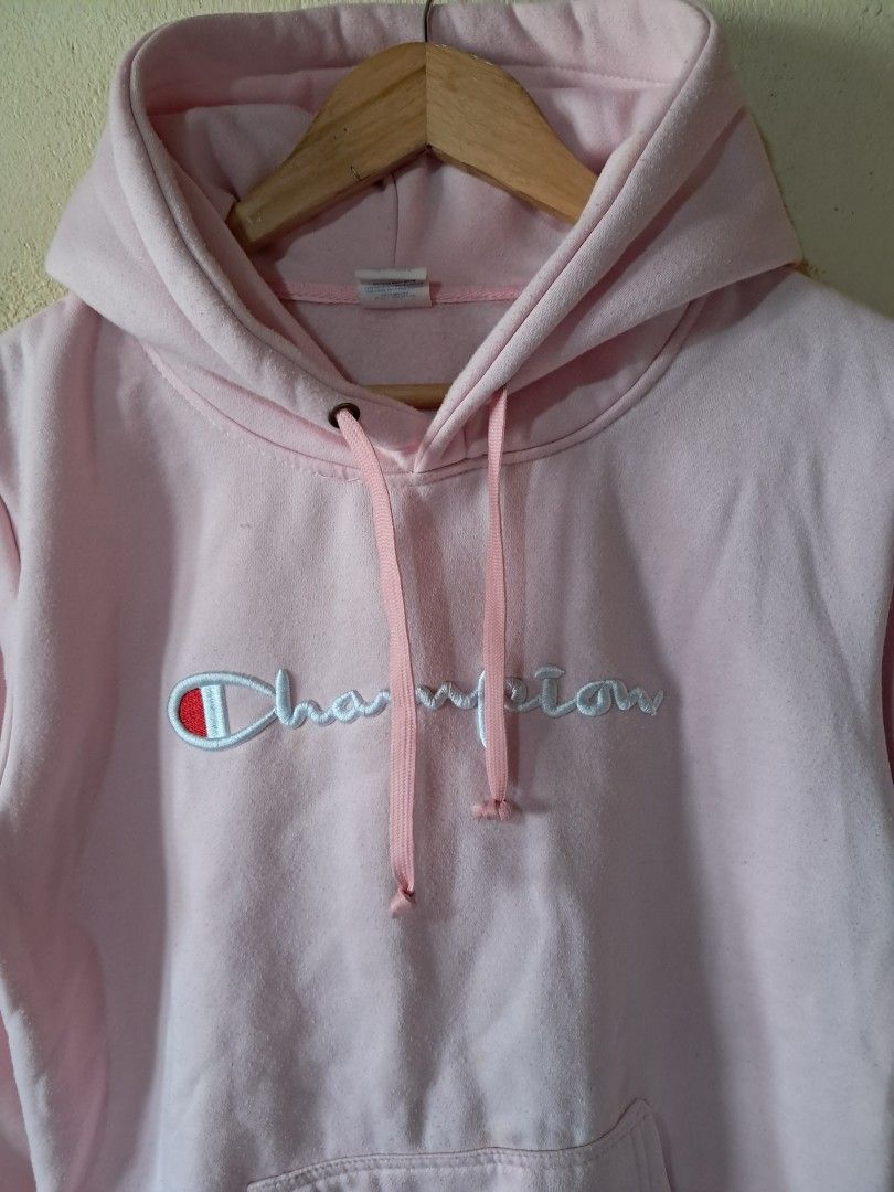Champion Pink Hoodie (Category: Coats, Jackets and Outerwear) located in Silang. Submitted by segundalifestyle (Listing ID 1443258782, Image 2). Description: - Classic pink Champion hoodie - Embroidered Champion logo on front - Pink drawstrings for hood - Made from soft, comfortable material - Ideal for everyday casual wear - 19 x 24 inches Dimension .