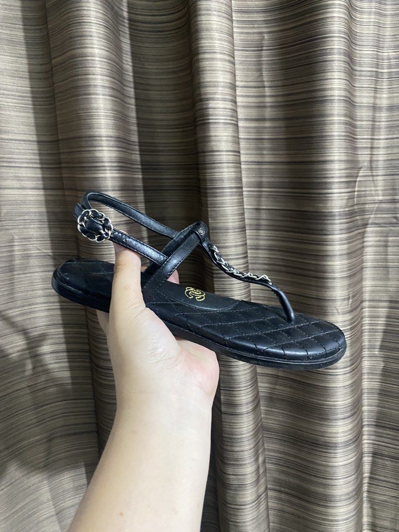 Chanel Black Quilted Leather Chain Sandals (Category: Sneakers & Footwear) located in Tacloban City. Submitted by houseofluxury.co (Listing ID 1443298828, Image 2). Description: - Authentic Chanel black quilted leather sandals - Iconic Chanel logo on insole - Thong style with adjustable ankle strap - Made in Italy - Size 39 - Some wear visible on the soles from normal use.