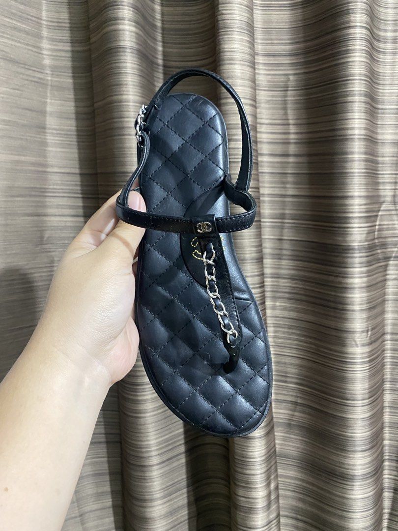 Chanel Black Quilted Leather Chain Sandals (Category: Sneakers & Footwear) located in Tacloban City. Submitted by houseofluxury.co (Listing ID 1443298828, Image 3). Description: - Authentic Chanel black quilted leather sandals - Iconic Chanel logo on insole - Thong style with adjustable ankle strap - Made in Italy - Size 39 - Some wear visible on the soles from normal use.