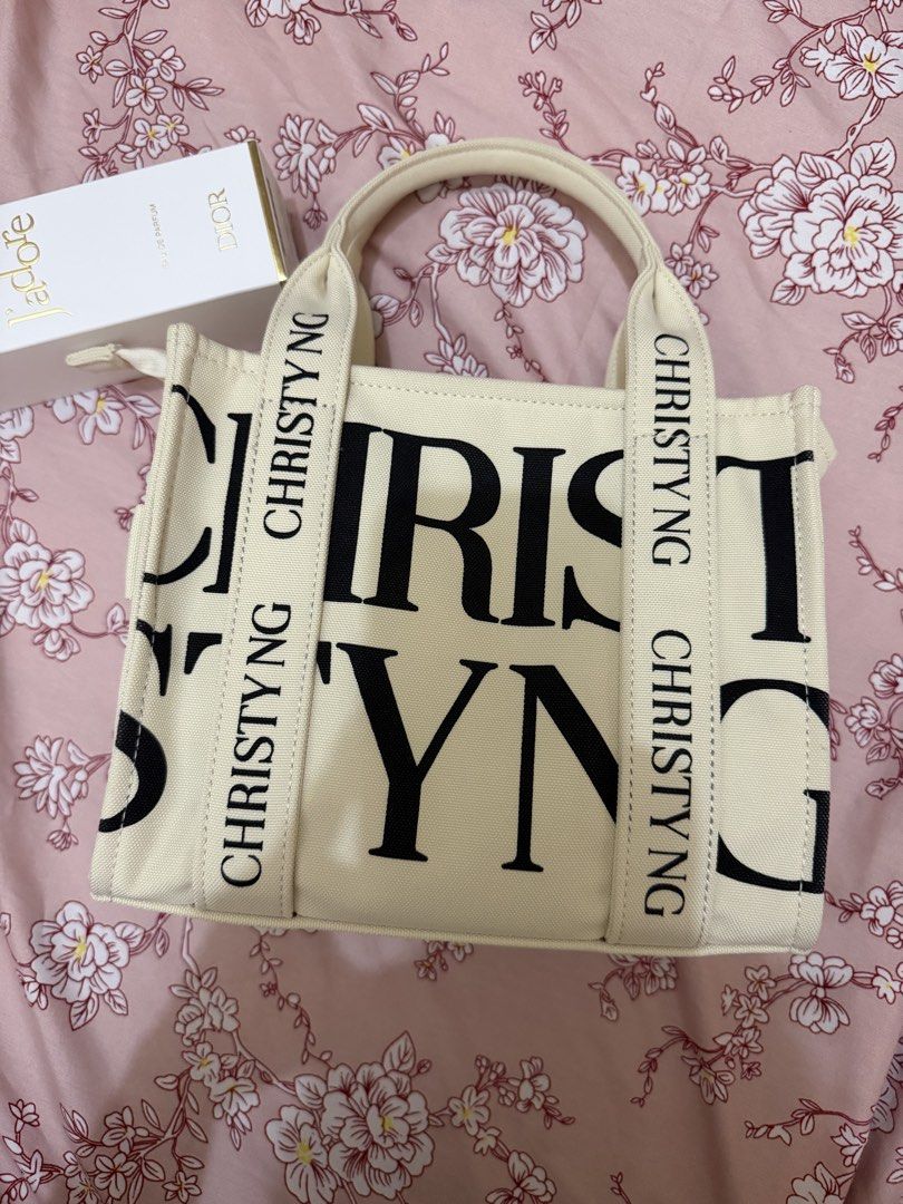 Christy Ng Canvas Mini Tote Bag (Category: Tote Bags) located in Manila. Submitted by lifeofchamppreloved (Listing ID 1443160532, Image 3). Description: Cristy Ng mini print tote bag. - Used once - With paper bag - Cream canvas tote bag - Zipper closure - Ideal for everyday use.
