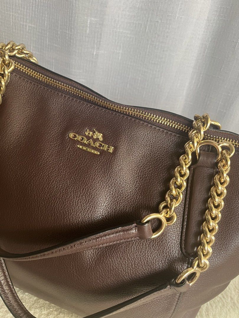 Coach Ava Chain Tote Bag (Category: Luxury Bags & Wallets) located in Paranaque City. Submitted by margagn (Listing ID 1443151309, Image 2). Description: Coach Ava Chain Tote in Oxblood F22211 - Material: Pebbled leather - Accents: Gold chain details - Straps: Leather - Closure: Zipper - Interior: Multiple compartments - Extras: Includes care instructions card SRP: $395 RFS: Not being used, just stored *Bought in Japan *Does not come with a dust 