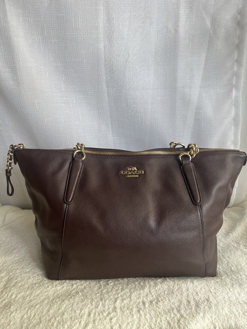 Coach Ava Chain Tote Bag (Category: Luxury Bags & Wallets) located in Paranaque City. Submitted by margagn (Listing ID 1443151309, Image 3). Description: Coach Ava Chain Tote in Oxblood F22211 - Material: Pebbled leather - Accents: Gold chain details - Straps: Leather - Closure: Zipper - Interior: Multiple compartments - Extras: Includes care instructions card SRP: $395 RFS: Not being used, just stored *Bought in Japan *Does not come with a dust 