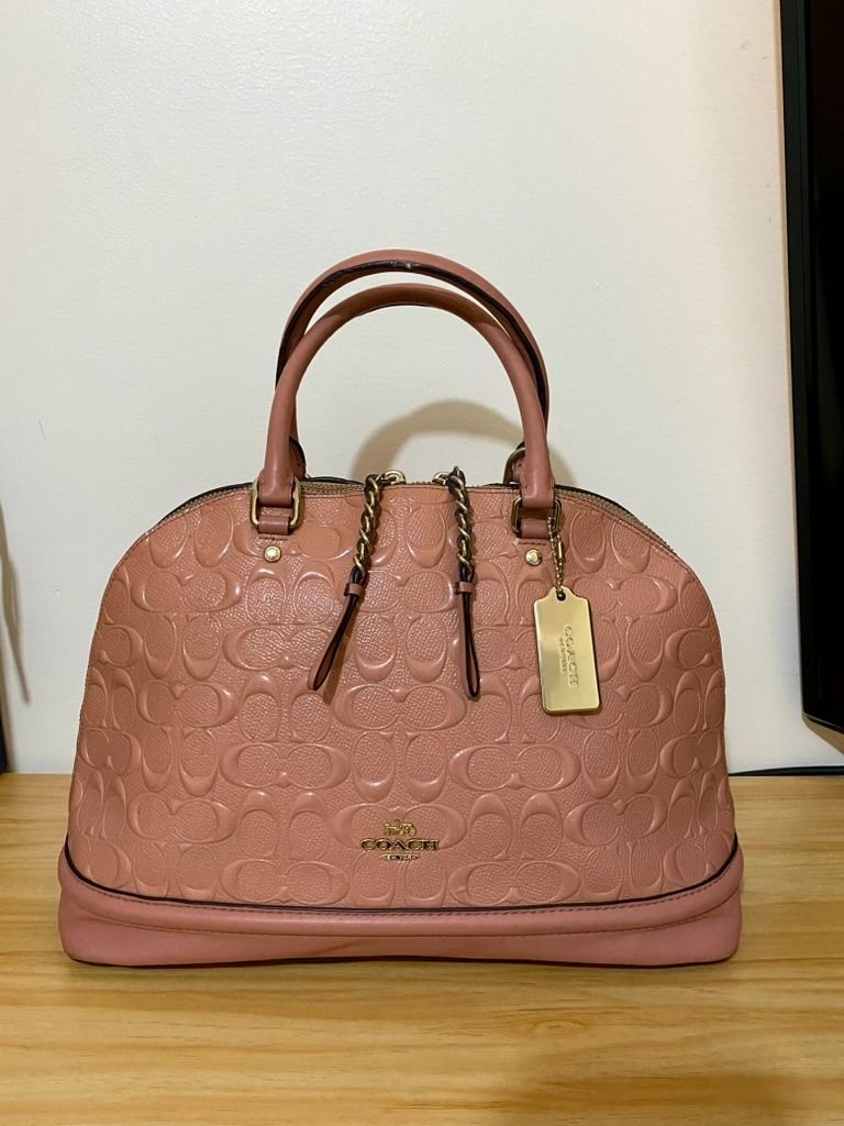 Coach Sierra Satchel Dome Longstrap (Category: Luxury Bags & Wallets) located in Manila. Submitted by kenvalero01923 (Listing ID 1443202465, Image 1). Description: Details: - Color: Blush 🩷 - Material: Signature embossed patent leather - Can be used as a handbag or shoulder bag (with crossbody strap) - 100% authentic Coach (check serial number) [F27598] 📌 Condition: - Bag is still in good condition - Creed/serial tag leather is peeling due to a